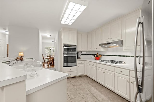 1418 Mill Path Loop, Lawrenceville, GA 30045 - kitchen featuring stainless steel appliances, under cabinet range hood, light tile patterned flooring, and light countertops