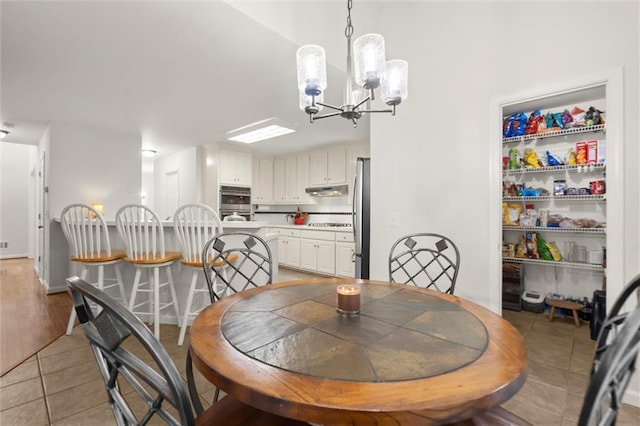 1418 Mill Path Loop, Lawrenceville, GA 30045 - dining room featuring a chandelier and light tile patterned floors