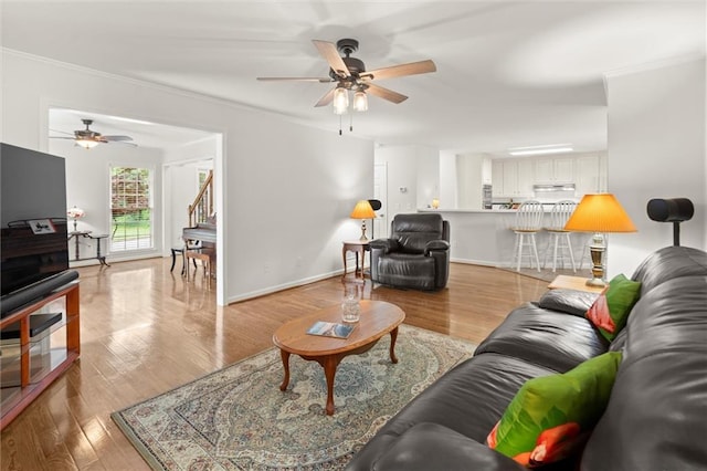 1418 Mill Path Loop, Lawrenceville, GA 30045 - living area featuring ceiling fan, light wood-style flooring, and ornamental molding