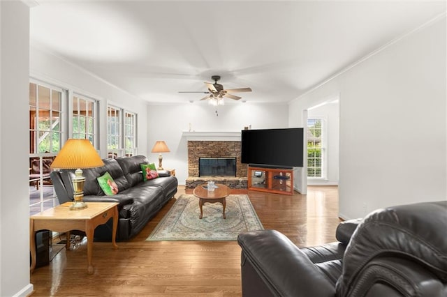 1418 Mill Path Loop, Lawrenceville, GA 30045 - living room with ceiling fan, wood finished floors, ornamental molding, and a stone fireplace