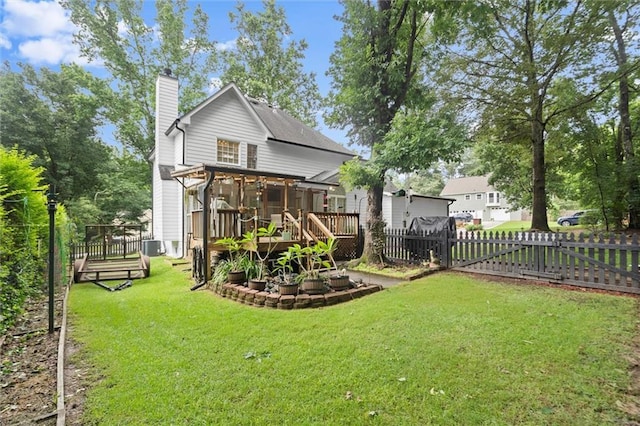 1418 Mill Path Loop, Lawrenceville, GA 30045 - rear view of property featuring a chimney, a wooden deck, a fenced backyard, and a sunroom