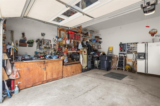 1418 Mill Path Loop, Lawrenceville, GA 30045 - garage with a workshop area, a garage door opener, and white refrigerator with ice dispenser