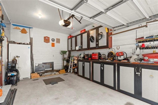 1418 Mill Path Loop, Lawrenceville, GA 30045 - garage featuring a workshop area, a garage door opener, and wood walls