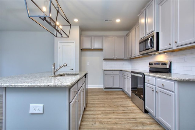 123 Greenview Ct Unit 1305, Homer, GA 30547 - kitchen with appliances with stainless steel finishes, gray cabinetry, a chandelier, light wood-style floors, and decorative backsplash
