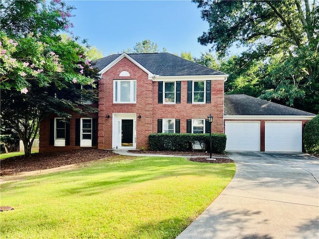 415 Wood Trace Ct, Alpharetta, GA 30022 - colonial home featuring driveway, a front lawn, brick siding, an attached garage, and roof with shingles