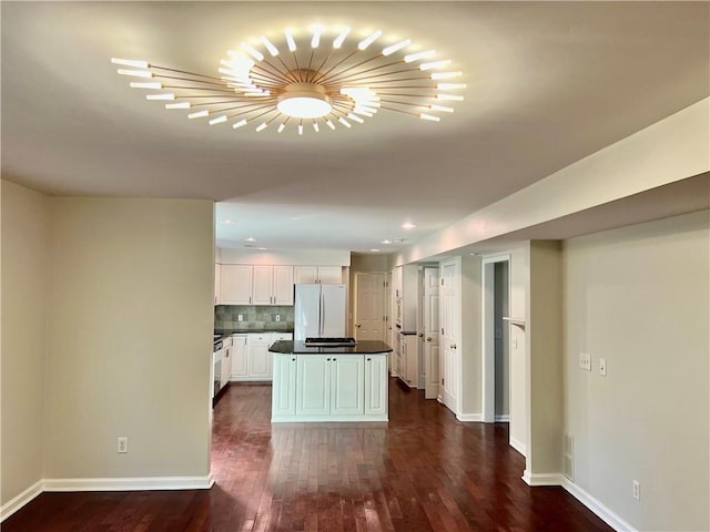 415 Wood Trace Ct, Alpharetta, GA 30022 - kitchen featuring freestanding refrigerator, dark countertops, dark wood-style floors, white cabinets, and backsplash