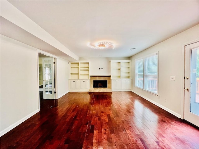 415 Wood Trace Ct, Alpharetta, GA 30022 - unfurnished living room with dark wood-style flooring, a fireplace with raised hearth, and built in features
