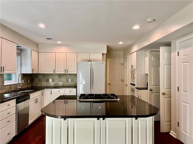 415 Wood Trace Ct, Alpharetta, GA 30022 - kitchen with stainless steel appliances, dark countertops, a kitchen island, white cabinetry, and recessed lighting