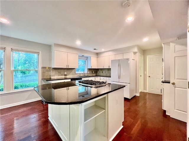 415 Wood Trace Ct, Alpharetta, GA 30022 - kitchen with freestanding refrigerator, dark countertops, dark wood-type flooring, white cabinetry, and recessed lighting