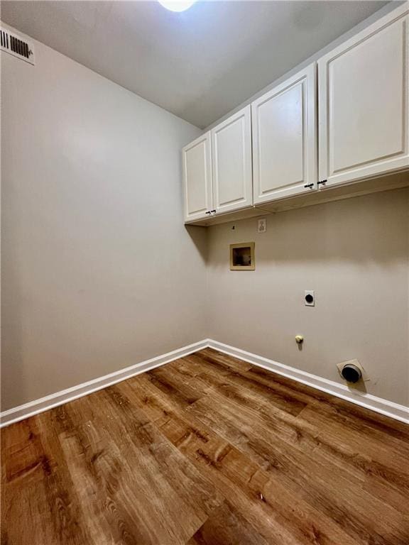 415 Wood Trace Ct, Alpharetta, GA 30022 - laundry room with electric dryer hookup, washer hookup, cabinet space, dark wood finished floors, and gas dryer hookup