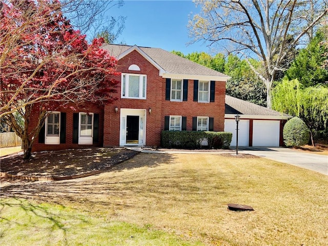 415 Wood Trace Ct, Alpharetta, GA 30022 - colonial house featuring driveway, an attached garage, a front lawn, brick siding, and a shingled roof