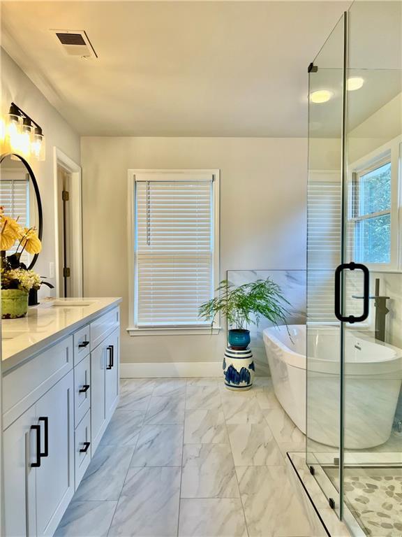 415 Wood Trace Ct, Alpharetta, GA 30022 - full bath featuring double vanity, marble finish flooring, and a soaking tub