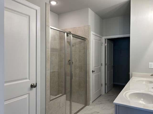 bathroom with vanity and a shower with shower door