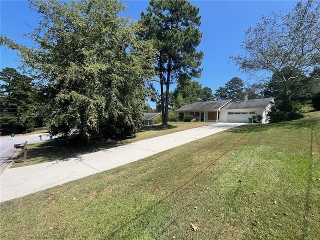 view of front of property with a garage, driveway, and a front yard