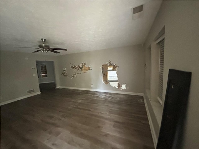 unfurnished living room featuring visible vents, a ceiling fan, baseboards, and wood finished floors