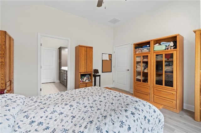 52 Lantern Trce, Hiram, GA 30141 - bedroom with baseboards, connected bathroom, a ceiling fan, light wood-style flooring, and vaulted ceiling