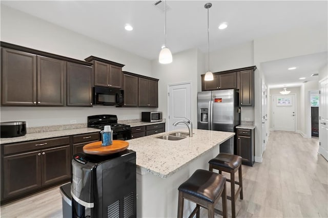 52 Lantern Trce, Hiram, GA 30141 - kitchen with a sink, a kitchen island with sink, black appliances, and dark brown cabinets