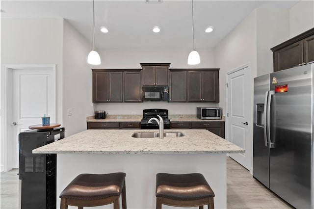 52 Lantern Trce, Hiram, GA 30141 - kitchen featuring a sink, black appliances, dark brown cabinets, and a kitchen bar