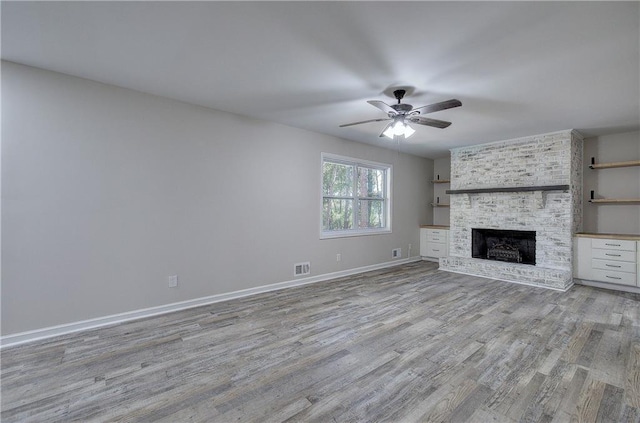 380 Inman Rd, Fayetteville, GA 30215 - unfurnished living room with a brick fireplace, light wood-style flooring, a ceiling fan, and baseboards