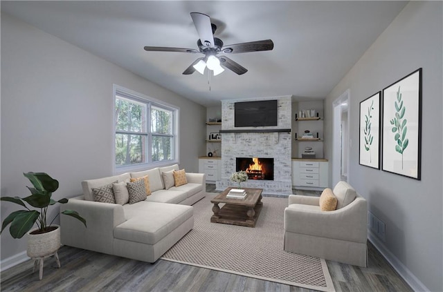 380 Inman Rd, Fayetteville, GA 30215 - living area featuring wood finished floors, a ceiling fan, a large fireplace, and baseboards