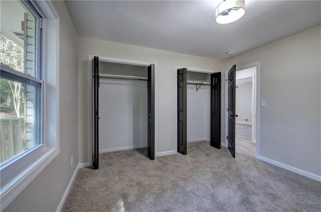 380 Inman Rd, Fayetteville, GA 30215 - unfurnished bedroom with multiple closets, carpet, and baseboards