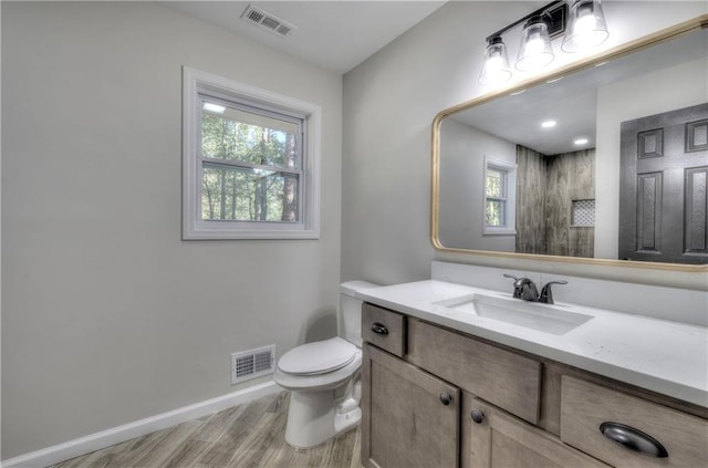 380 Inman Rd, Fayetteville, GA 30215 - bathroom featuring wood finished floors, toilet, vanity, baseboards, and a shower