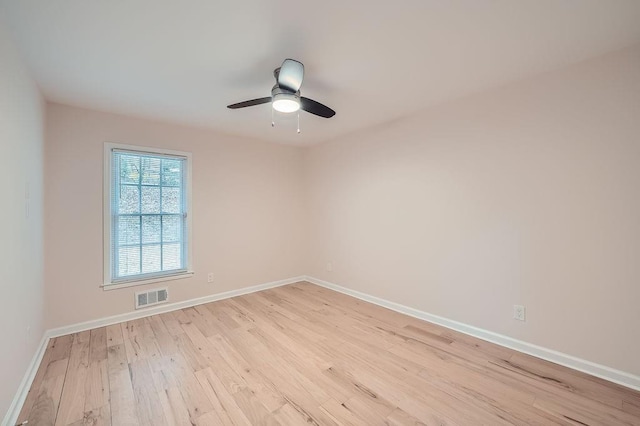 unfurnished room with light wood-type flooring, baseboards, visible vents, and a ceiling fan