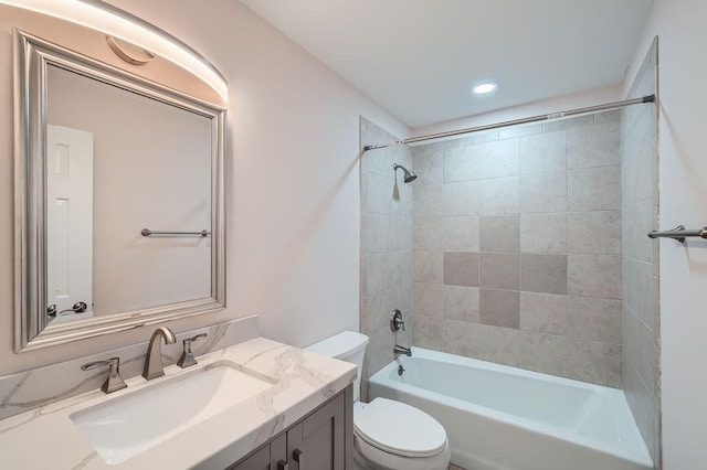 bathroom featuring bathing tub / shower combination, vanity, and toilet