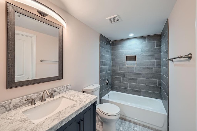 full bath featuring visible vents, vanity, toilet, and tub / shower combination