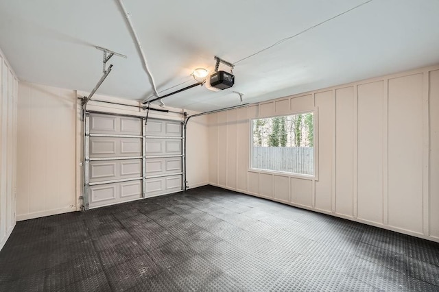 garage featuring a garage door opener and a decorative wall