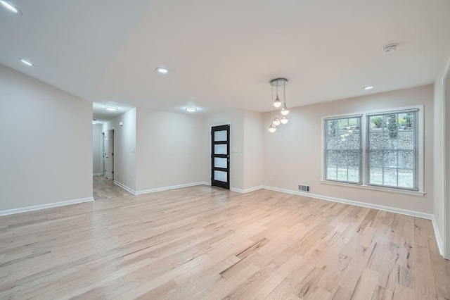 spare room featuring baseboards, recessed lighting, visible vents, and light wood-style floors