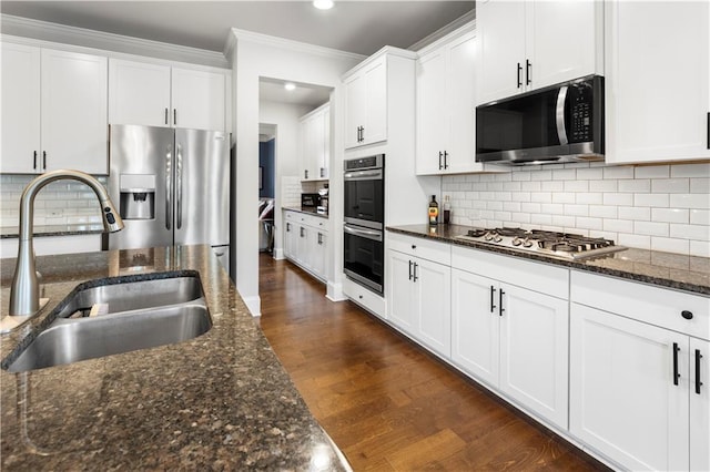 216 Orchard Trl, Canton, GA 30115 - kitchen with stainless steel appliances, a sink, ornamental molding, dark wood-type flooring, and white cabinets