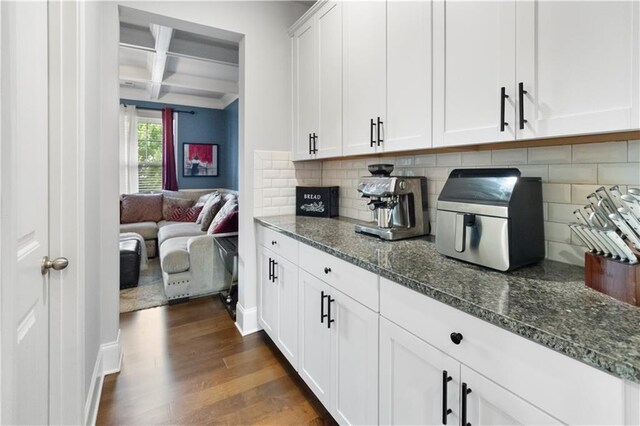 216 Orchard Trl, Canton, GA 30115 - kitchen featuring coffered ceiling, decorative backsplash, dark wood-style floors, dark stone counters, and beamed ceiling