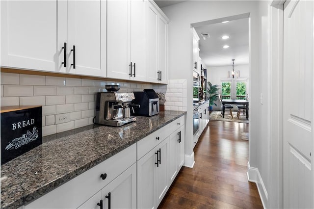 216 Orchard Trl, Canton, GA 30115 - kitchen with dark wood-type flooring, white cabinetry, tasteful backsplash, dark stone counters, and recessed lighting