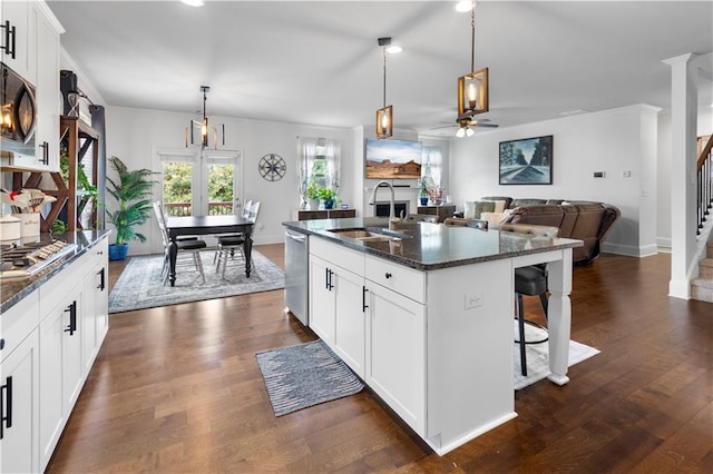 216 Orchard Trl, Canton, GA 30115 - kitchen featuring a sink, appliances with stainless steel finishes, a kitchen breakfast bar, a ceiling fan, and a center island with sink