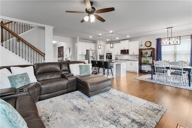 216 Orchard Trl, Canton, GA 30115 - living room with ceiling fan, light wood-style flooring, stairs, recessed lighting, and a chandelier