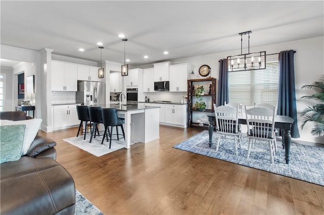 216 Orchard Trl, Canton, GA 30115 - kitchen featuring appliances with stainless steel finishes, healthy amount of natural light, open floor plan, recessed lighting, and tasteful backsplash