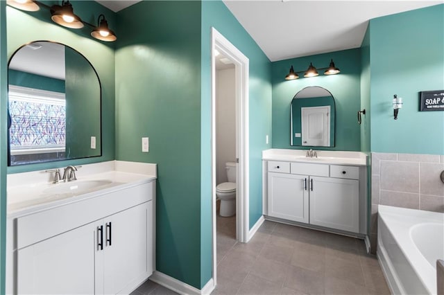 216 Orchard Trl, Canton, GA 30115 - full bathroom with tile patterned floors, toilet, two vanities, a bath, and baseboards