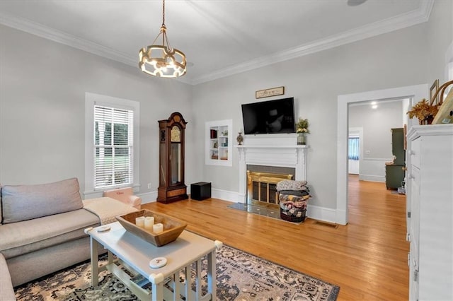 1238 Macland Rd, Dallas, GA 30132 - living room with a fireplace with flush hearth, light wood finished floors, a chandelier, and ornamental molding