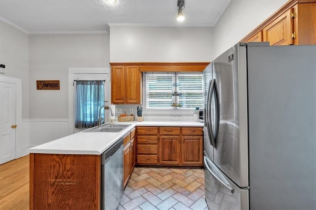 1238 Macland Rd, Dallas, GA 30132 - kitchen featuring appliances with stainless steel finishes, brown cabinetry, ornamental molding, a peninsula, and a wainscoted wall