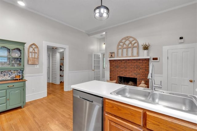 1238 Macland Rd, Dallas, GA 30132 - kitchen with stainless steel dishwasher, crown molding, light wood-style flooring, light countertops, and a wainscoted wall