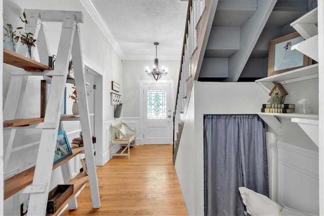 1238 Macland Rd, Dallas, GA 30132 - foyer entrance featuring a chandelier, light wood-style floors, crown molding, and a textured ceiling