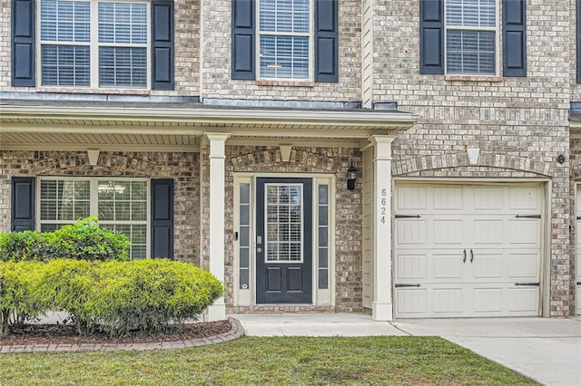 property entrance featuring covered porch and a garage