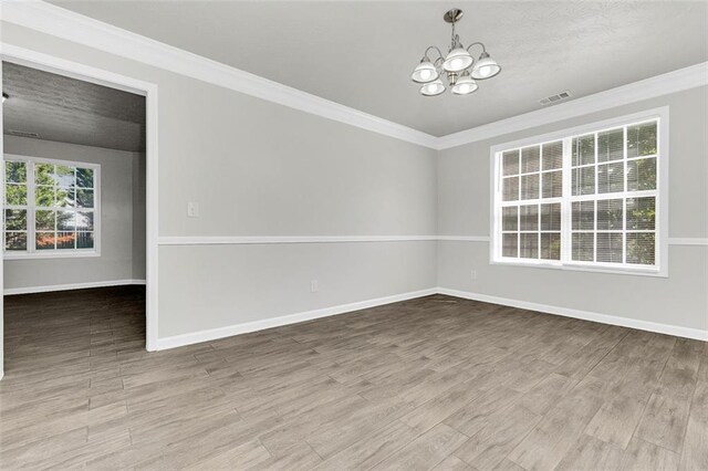 2146 Silva Ct, Conley, GA 30288 - unfurnished room with a chandelier, wood finished floors, crown molding, and baseboards