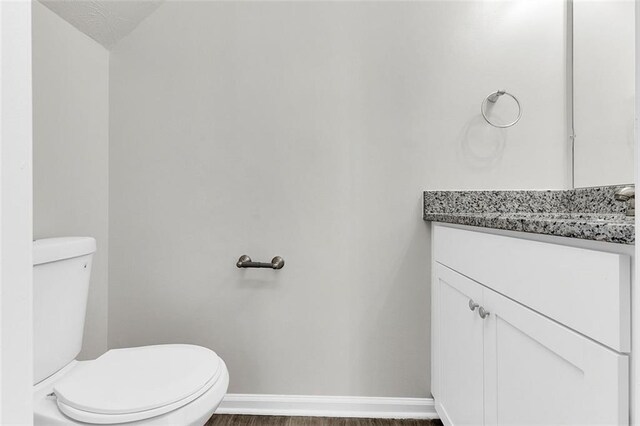2146 Silva Ct, Conley, GA 30288 - bathroom with wood finished floors, vanity, toilet, and baseboards