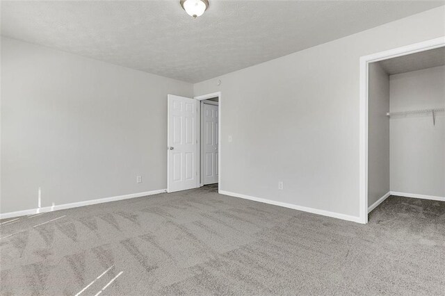 2146 Silva Ct, Conley, GA 30288 - unfurnished bedroom with carpet floors, baseboards, a textured ceiling, and a closet