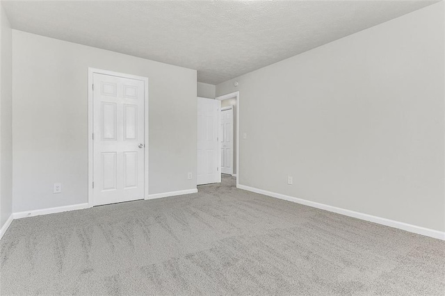 2146 Silva Ct, Conley, GA 30288 - unfurnished bedroom featuring carpet, baseboards, and a textured ceiling