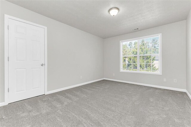 2146 Silva Ct, Conley, GA 30288 - carpeted spare room featuring baseboards and a textured ceiling