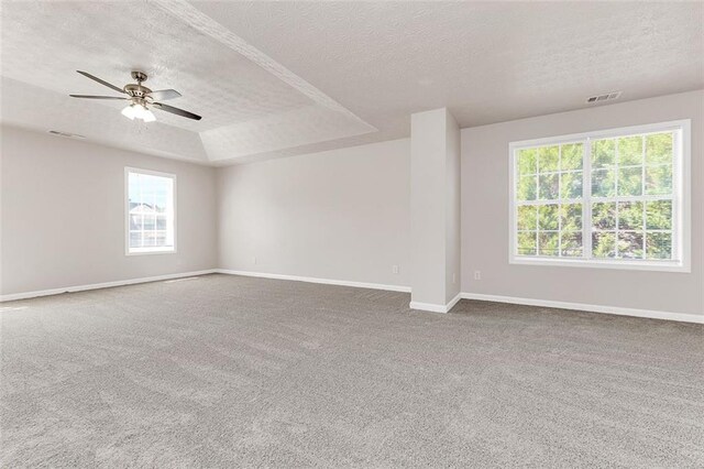 2146 Silva Ct, Conley, GA 30288 - empty room with a textured ceiling, carpet flooring, a ceiling fan, baseboards, and a tray ceiling