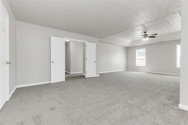2146 Silva Ct, Conley, GA 30288 - spare room featuring a textured ceiling, ceiling fan, carpet, and baseboards